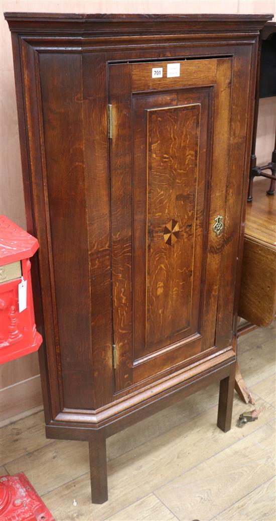 A late 18th century inlaid oak hanging corner cupboard W.84cm